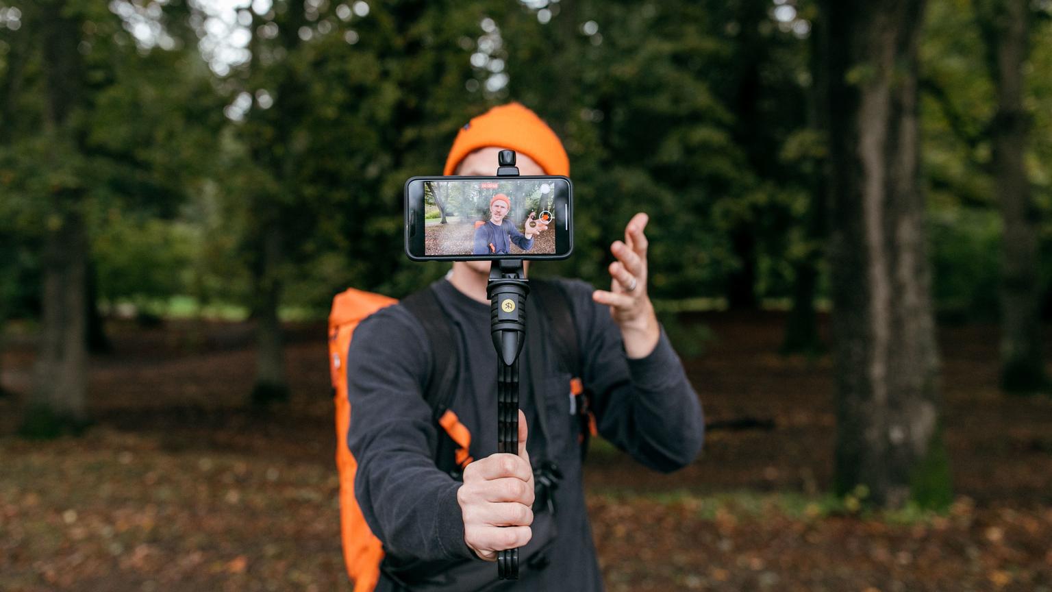 Switchpod - A man holding the switchpod tripod while vlogging.