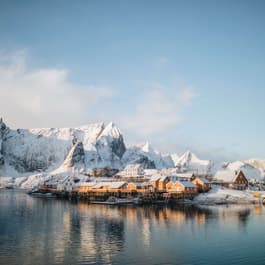 The iconic yellow cabins along the coast of the Lofoten Islands, blanketed in snow