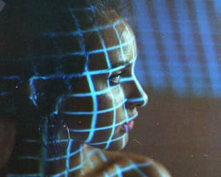 Film Photo of girl with blue grid of light on face