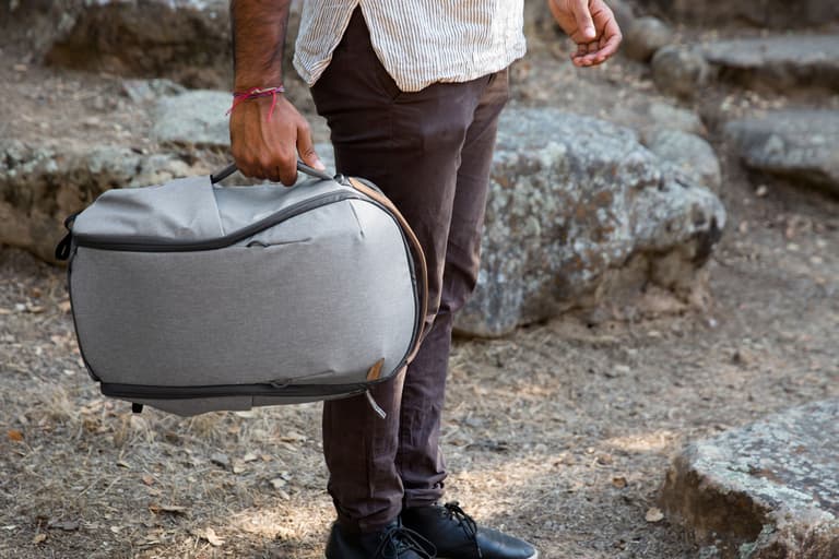 Peak Design Everyday Zip Backpack - Man wearing the zip backpack in the color ash.