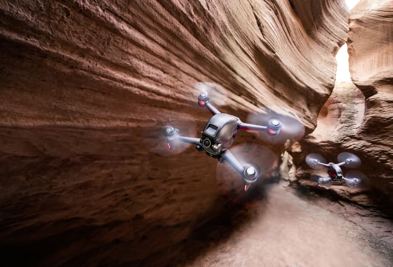 Moment DJI lifestyle two drones flying in cavern