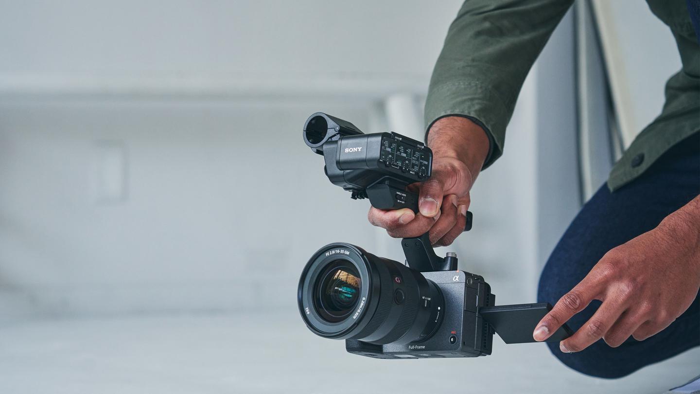Man holding cinema camera for an article titled: Sony FX3's Built-in Anamorphic Features Make It a Filmmaker's Choice