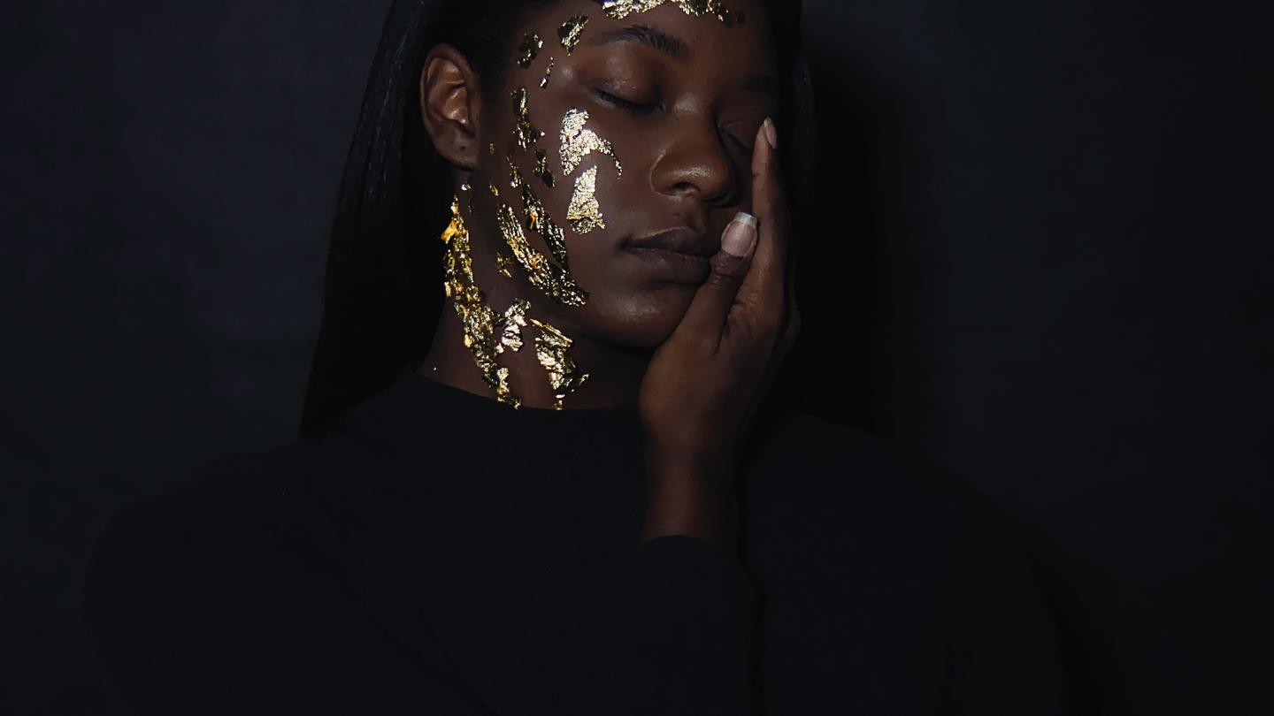 iPhone 11 - A creative portrait of a woman with gold rust on her face.