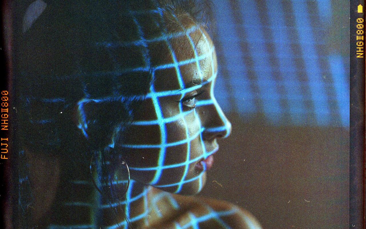 Film Photo of girl with blue grid of light on face