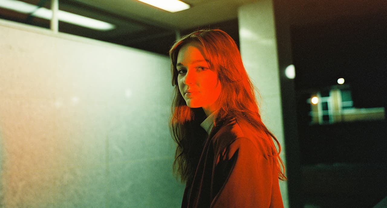 Film photo of girl lighted with red and green light