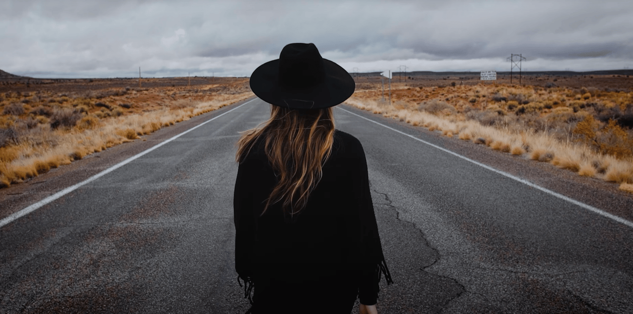 Lilas color grading work Woman with hat walking on road