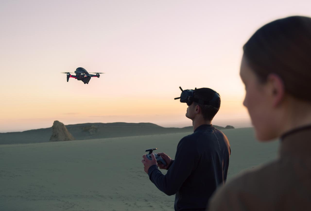Moment DJI lifestyle man women flying drone in desert