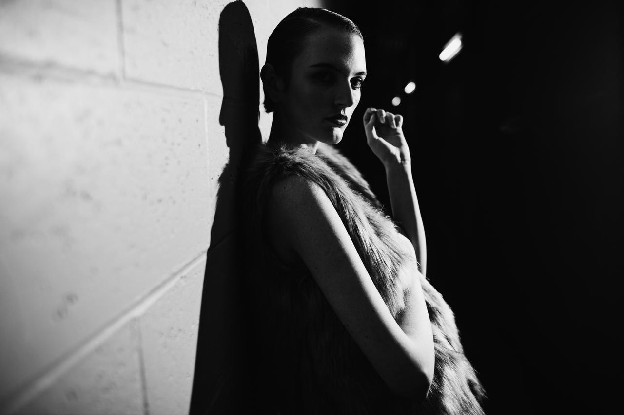 Black and white portrait of female model in a hallway