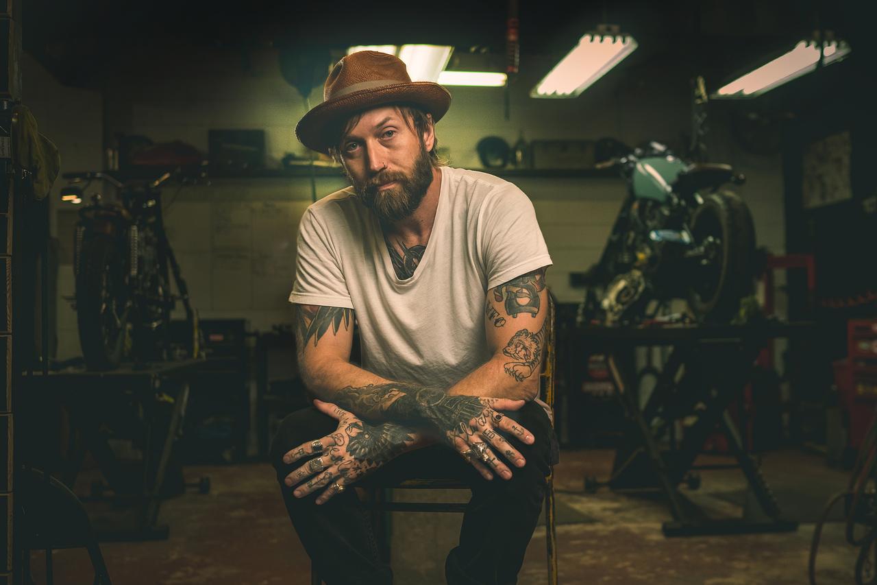 Portrait of tattooed man in a motorcycle shop