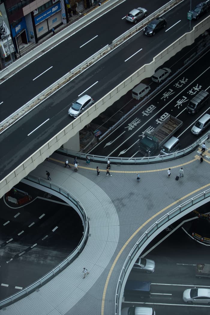 An aerial view of the highways in Japan with both cars and people passing through