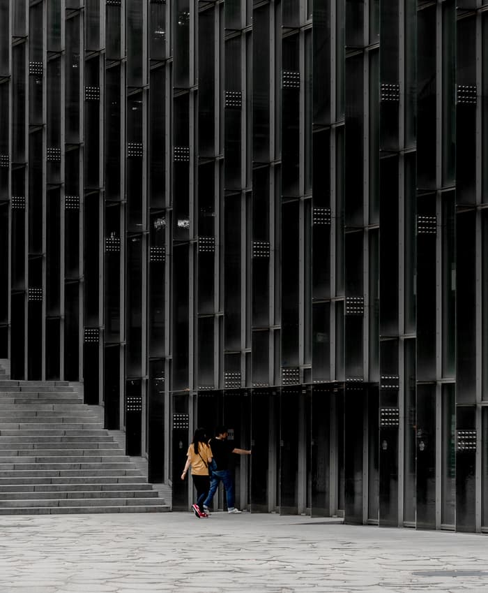 Two people walk through the doors of the Ewha Women's University in Seoul, South Korea